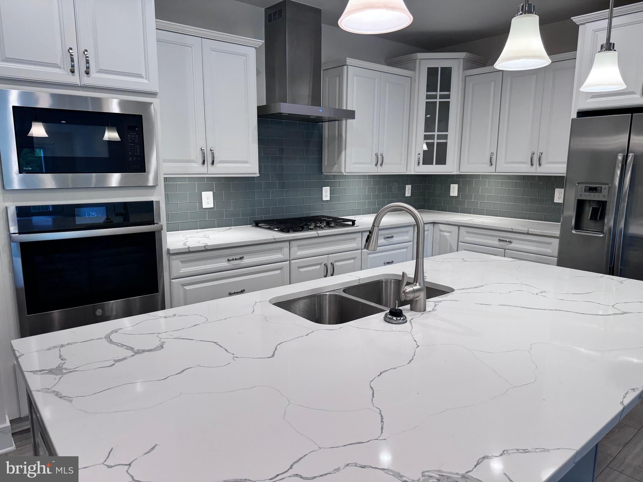 1000 Herons Nest Way, Unit 32 Chester, MD 21619 - Photo 1 of 28 a kitchen with stainless steel appliances a stove a sink and white cabinets