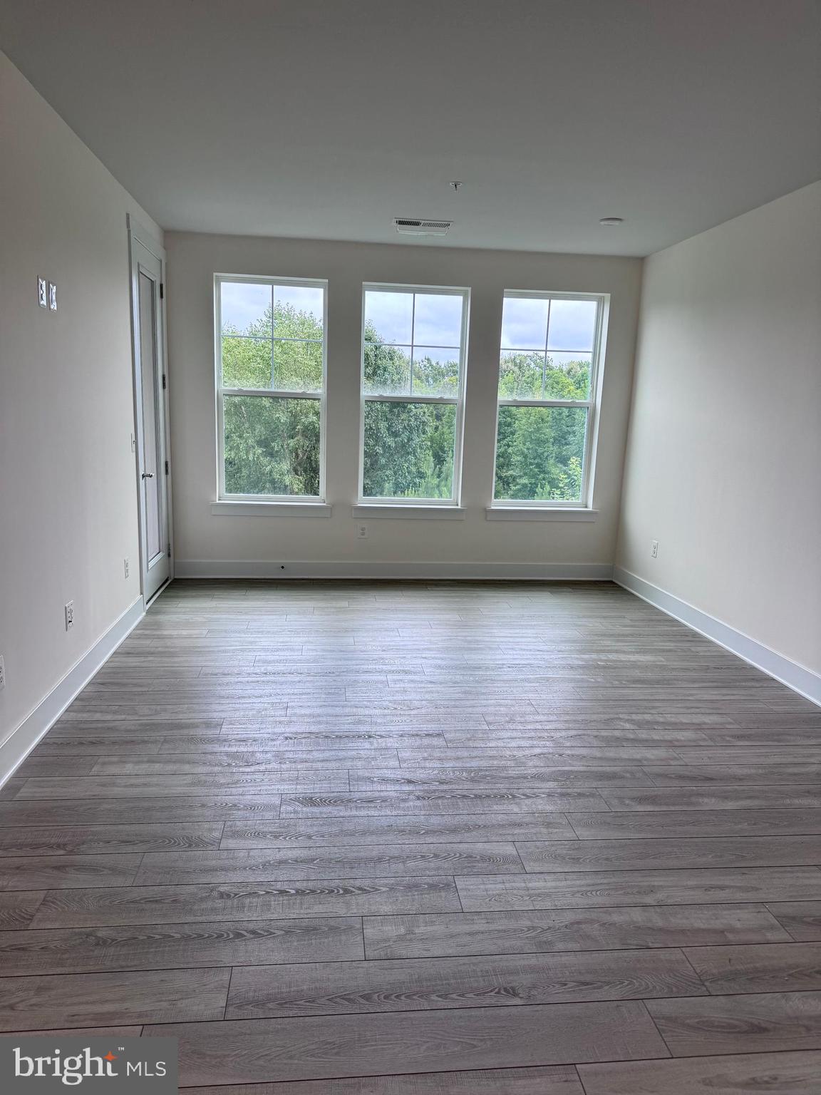 1000 Herons Nest Way, Unit 32 Chester, MD 21619 - Photo 13 of 28 a view of empty room with wooden floor and fan