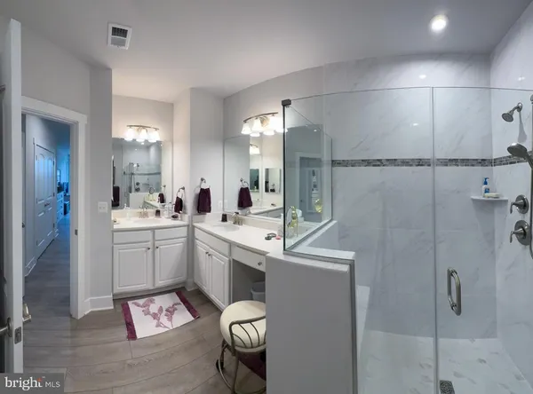 a room with a sink toilet and shower