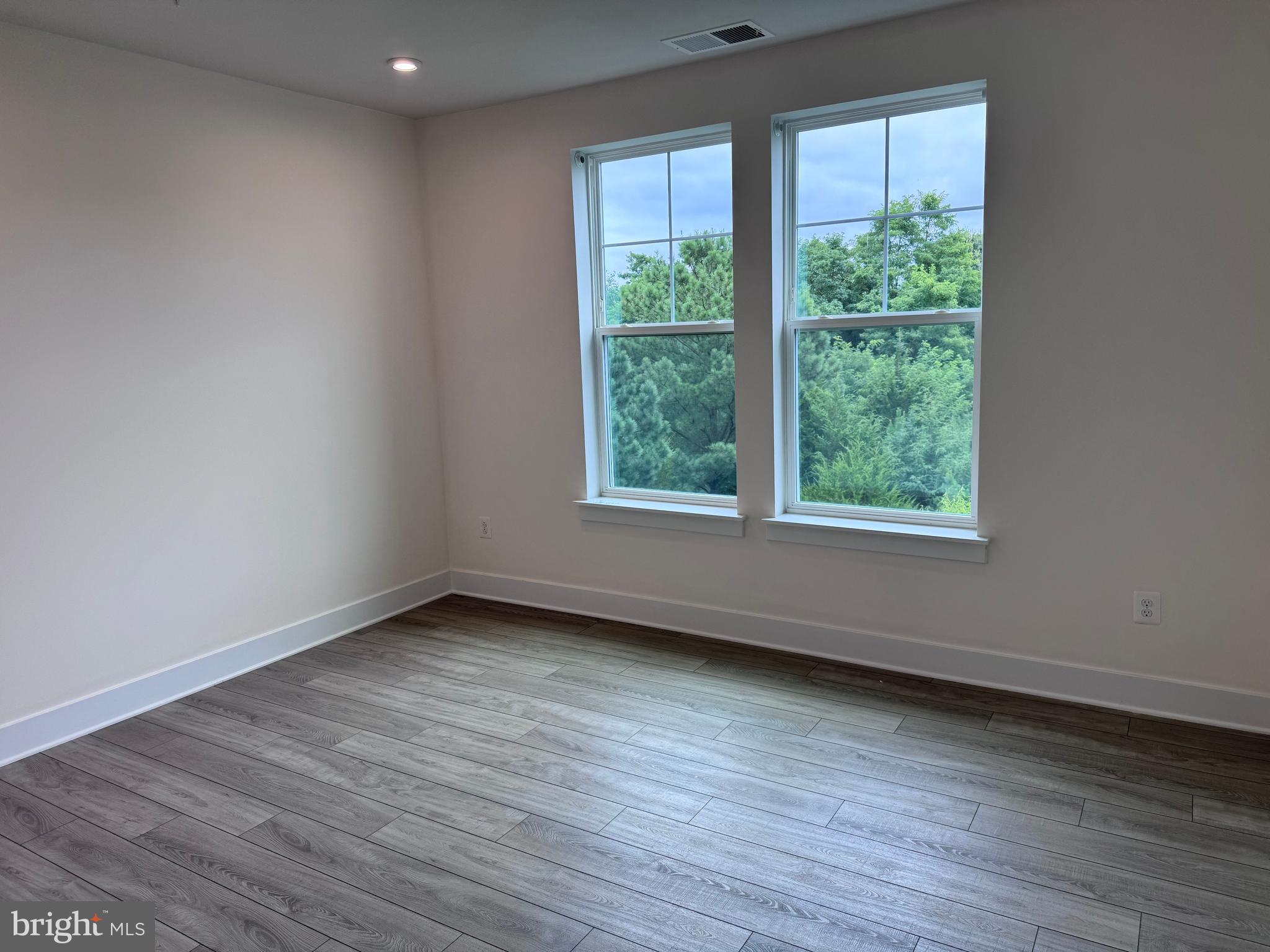 1000 Herons Nest Way, Unit 32 Chester, MD 21619 - Photo 16 of 28 an empty room with wooden floor and windows