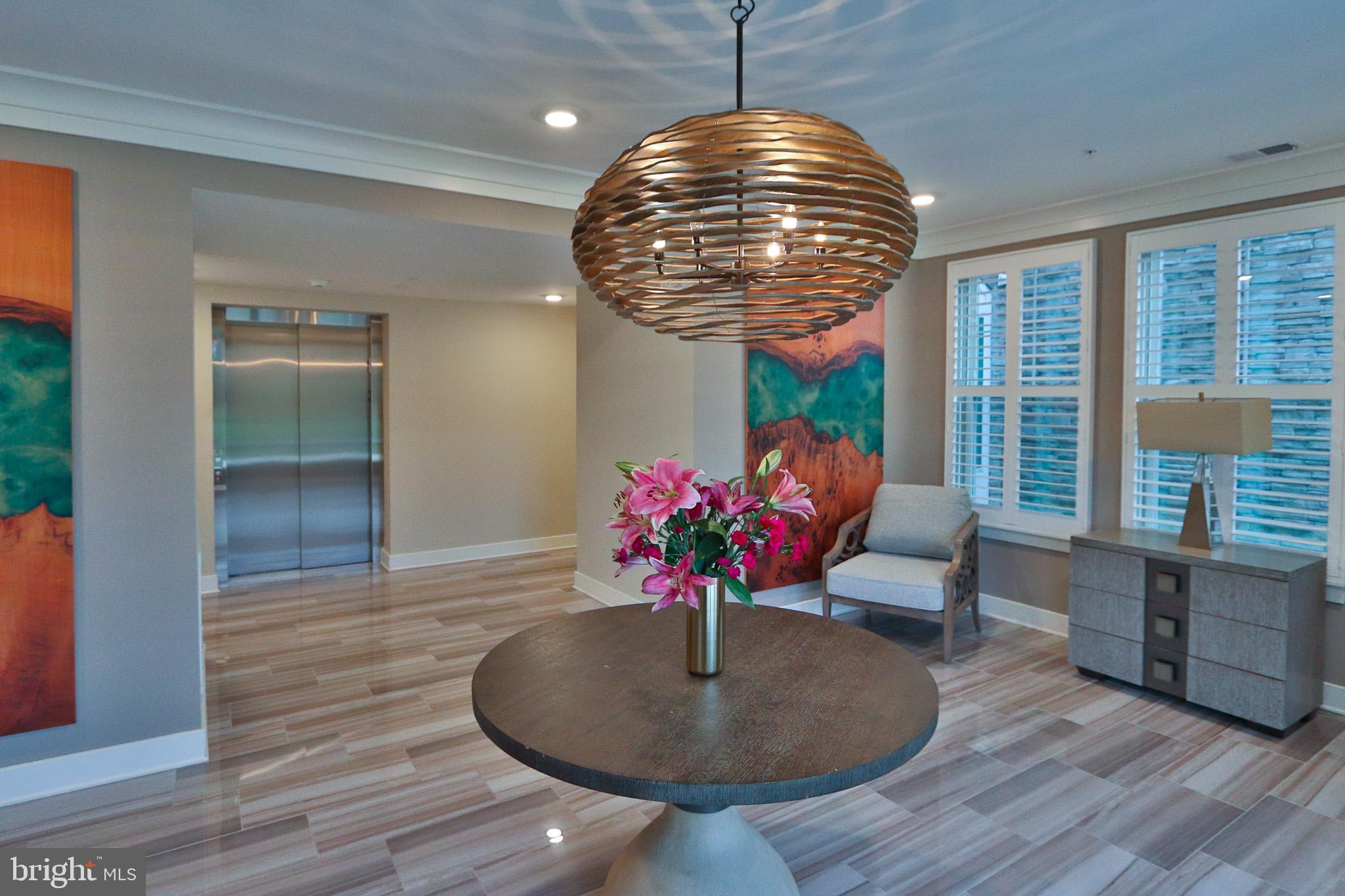 1000 Herons Nest Way, Unit 32 Chester, MD 21619 - Photo 20 of 28 a lobby room with furniture and potted plants