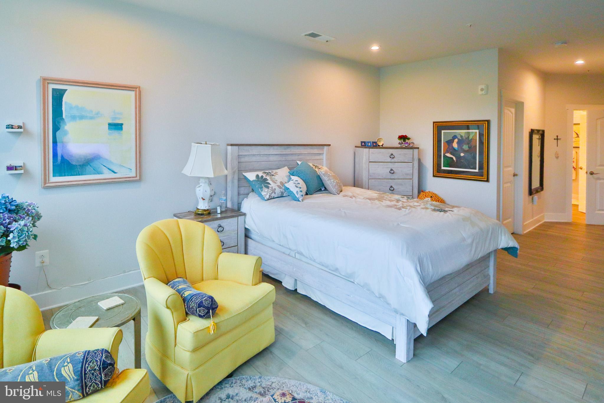 1000 Herons Nest Way, Unit 32 Chester, MD 21619 - Photo 25 of 28 a bedroom with a bed and wooden floor