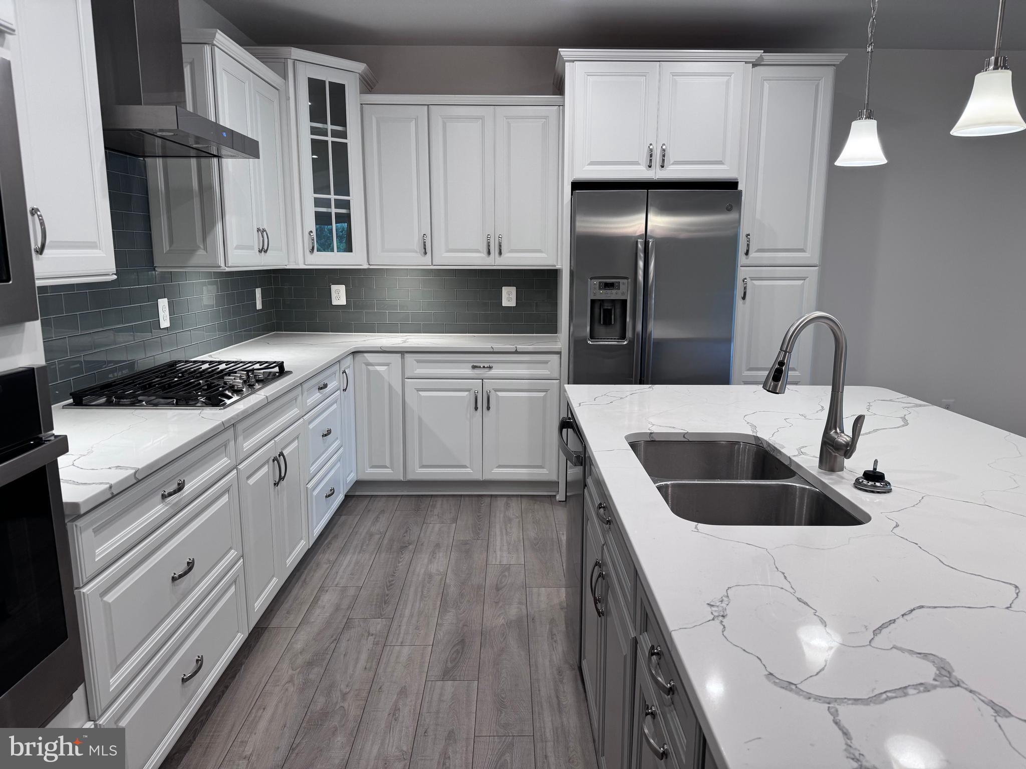 1000 Herons Nest Way, Unit 32 Chester, MD 21619 - Photo 3 of 28 a kitchen with stainless steel appliances granite countertop a sink stove and refrigerator