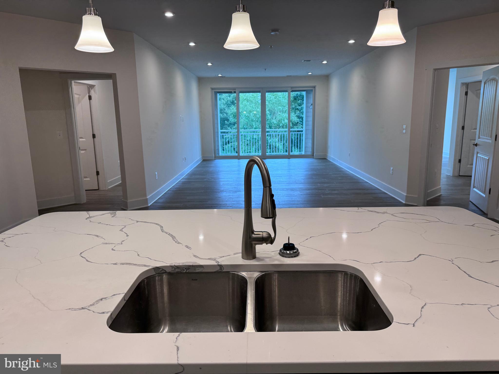 1000 Herons Nest Way, Unit 32 Chester, MD 21619 - Photo 4 of 28 a kitchen with a sink and a large mirror