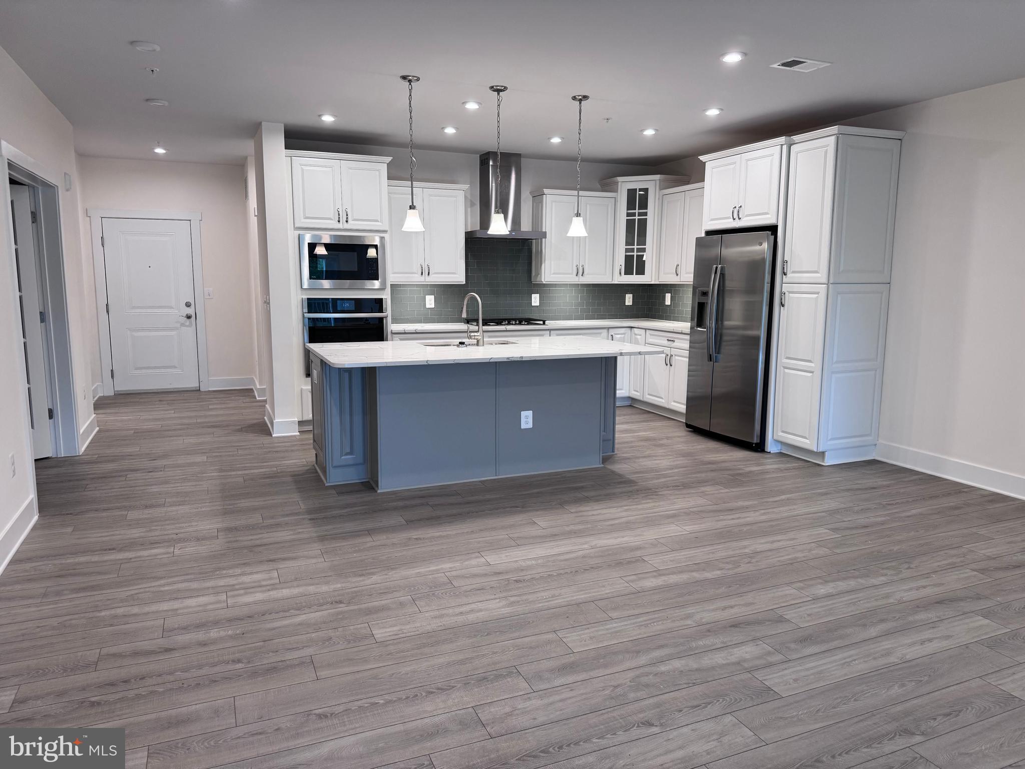 1000 Herons Nest Way, Unit 32 Chester, MD 21619 - Photo 5 of 28 a large kitchen with stainless steel appliances granite countertop a large counter top and a stove