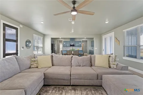 a living room with furniture and a large window