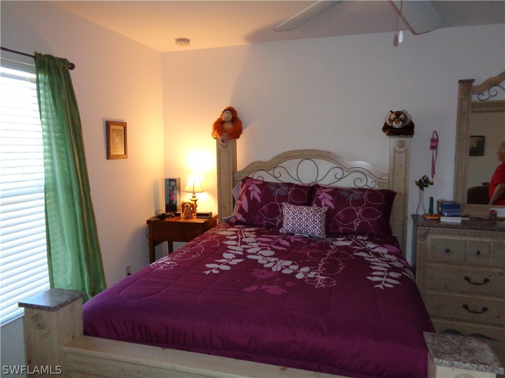 2512 53rd Street West Lehigh Acres, FL 33971 - Photo 17 of 25 a large bed sitting in a bedroom next to a window