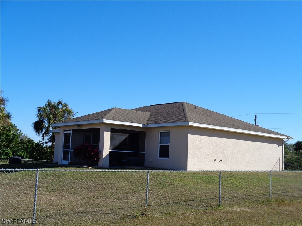 2512 53rd Street West Lehigh Acres, FL 33971 - Photo 2 of 25 a front view of a house with a garage
