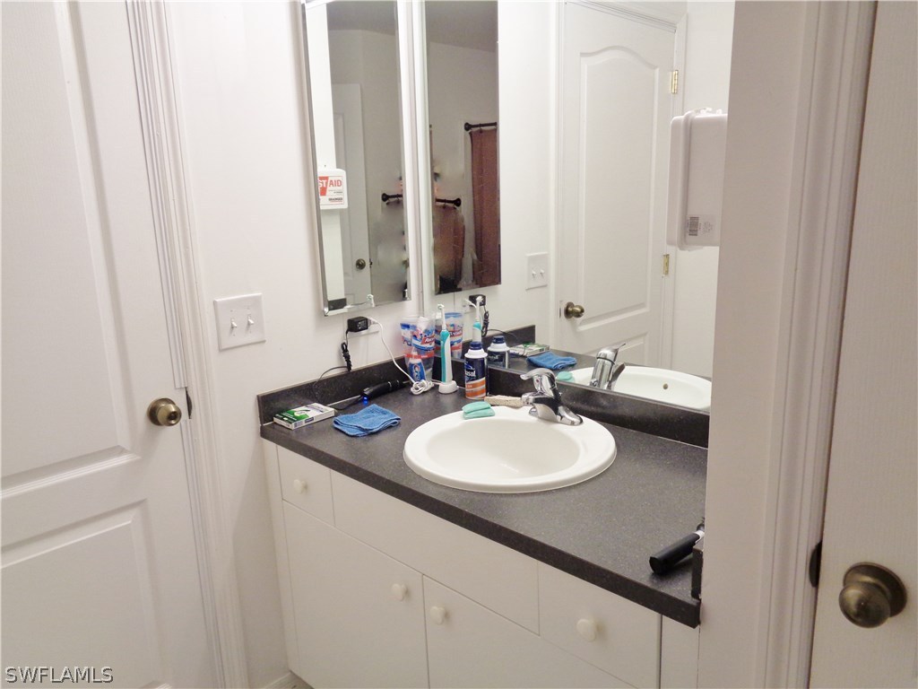 2512 53rd Street West Lehigh Acres, FL 33971 - Photo 22 of 25 a bathroom with a sink and a mirror