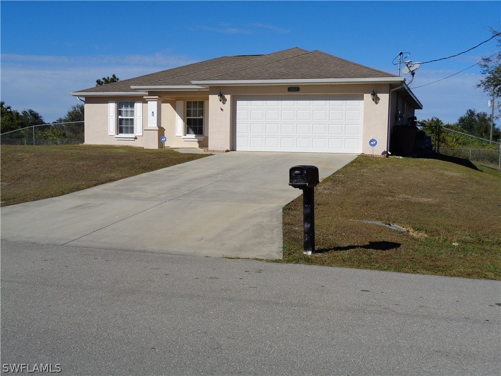 2512 53rd Street West Lehigh Acres, FL 33971 - Photo 23 of 25 a front view of a house with a yard
