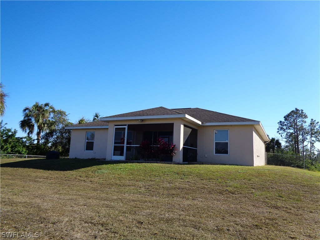 2512 53rd Street West Lehigh Acres, FL 33971 - Photo 24 of 25 a front view of a house with a garden