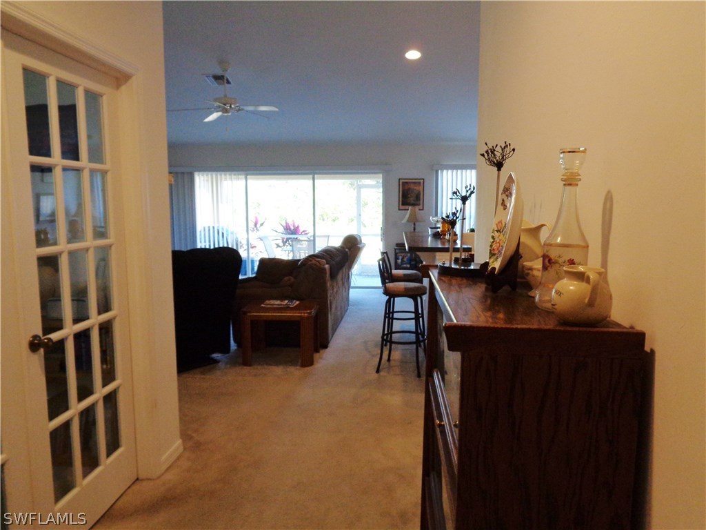 2512 53rd Street West Lehigh Acres, FL 33971 - Photo 6 of 25 a living room with furniture a large window and flat screen tv