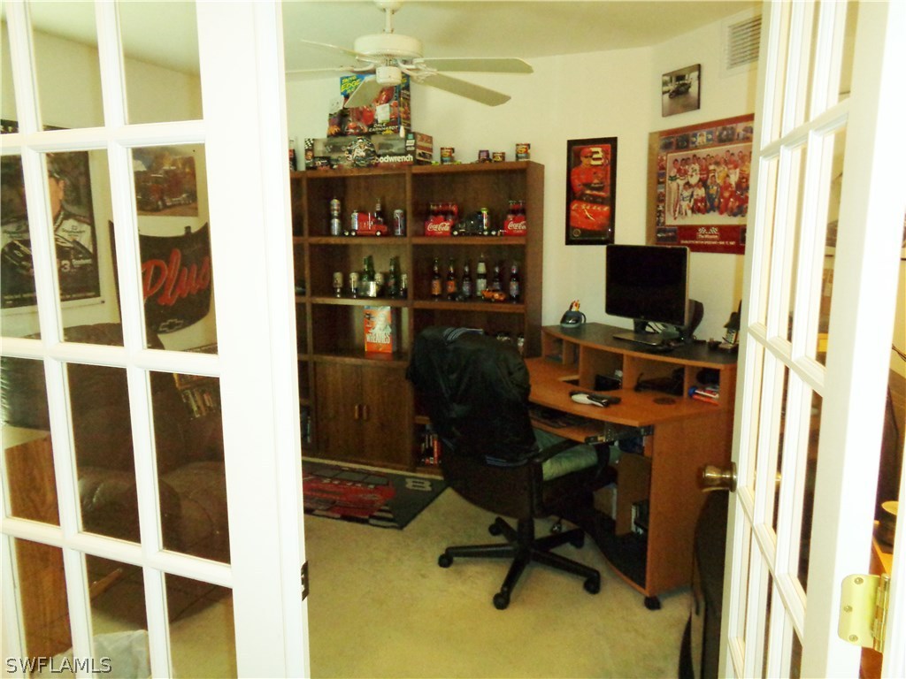 2512 53rd Street West Lehigh Acres, FL 33971 - Photo 7 of 25 a view of a workspace with furniture and a window