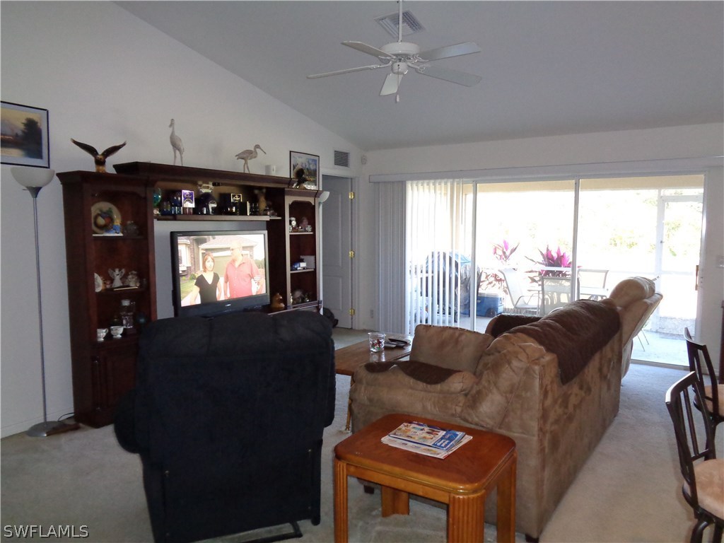 2512 53rd Street West Lehigh Acres, FL 33971 - Photo 10 of 25 a living room with furniture and a flat screen tv