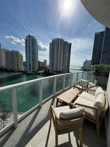 a balcony with furniture and a potted plant