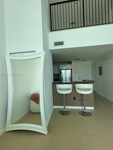 a bathroom with a toilet and a shower curtain