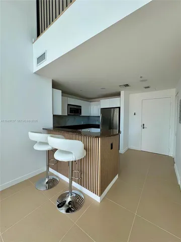a kitchen with stainless steel appliances a stove sink and cabinets