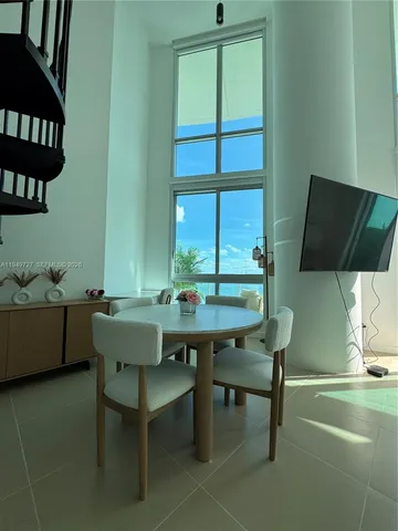 a view of a dining room with furniture window and outside view