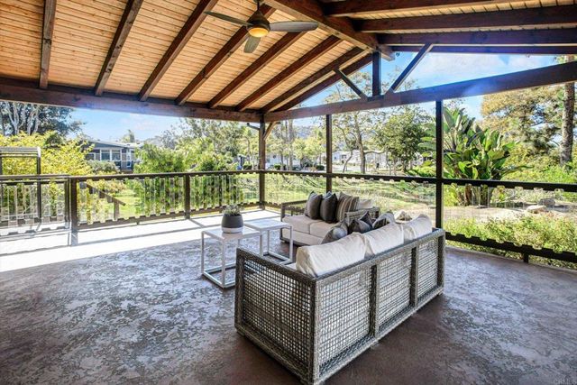 a yard with lots of green space and trees