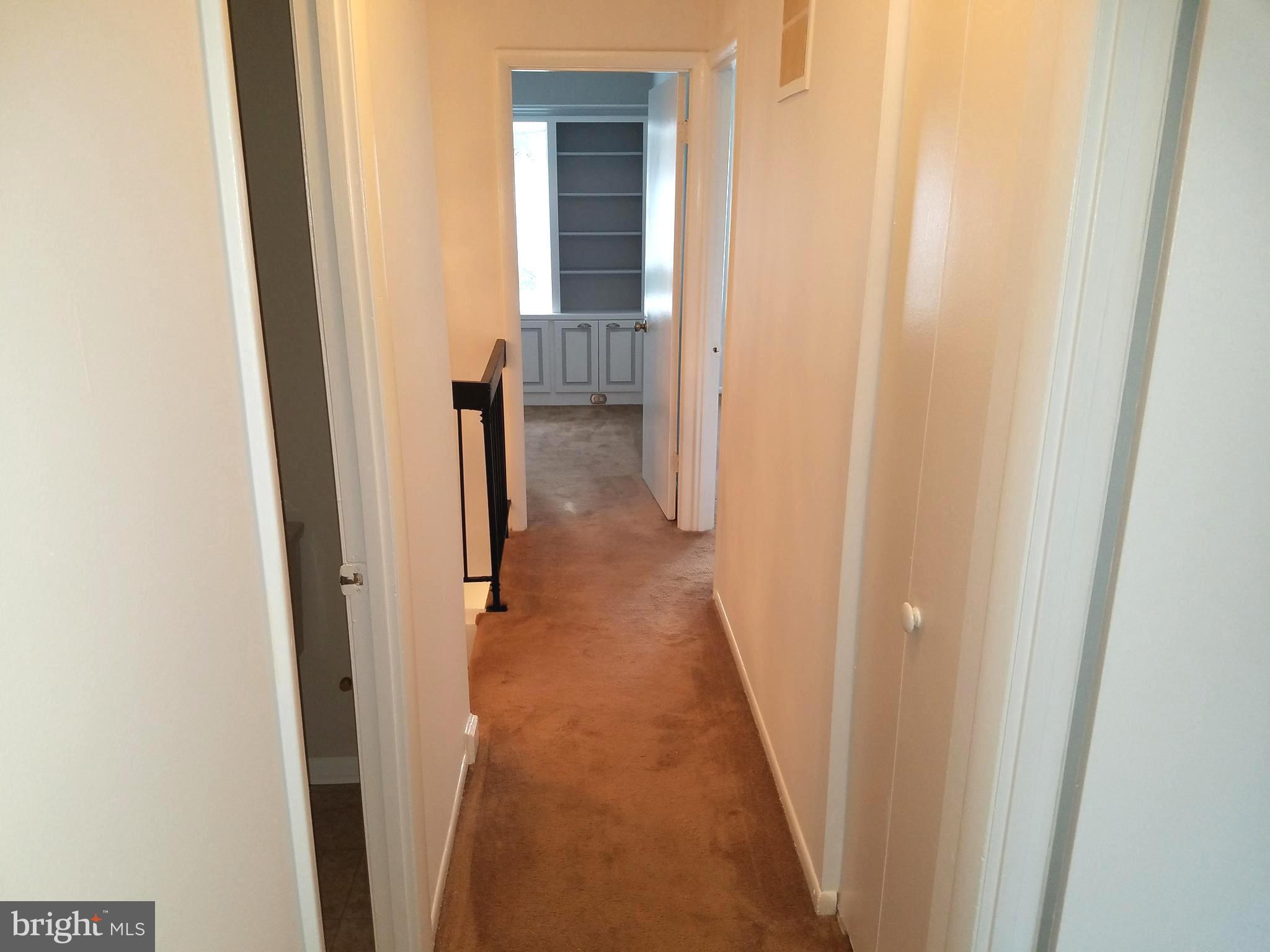 17433 Hughes Road Poolesville, MD 20837 - Photo 13 of 20 a view of a hallway with wooden floor