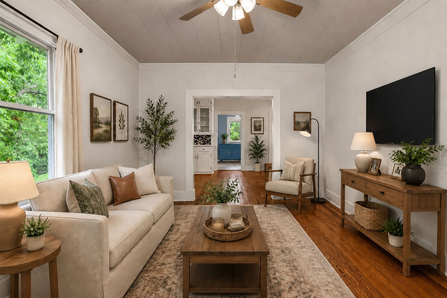 1002 Washburn Street Taylor, TX 76574 - Photo 5 of 29 Hardwood floors and a welcoming archway define this inviting living space.