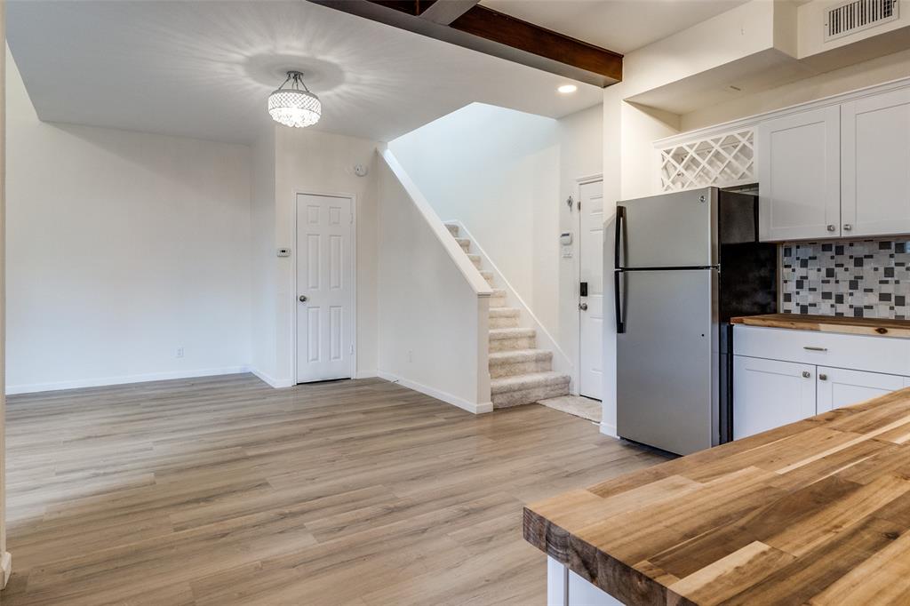 8404 Forest Lane, Unit 702 Dallas, TX 75243 - Photo 5 of 12 a view of a kitchen with wooden floor and electronic appliances