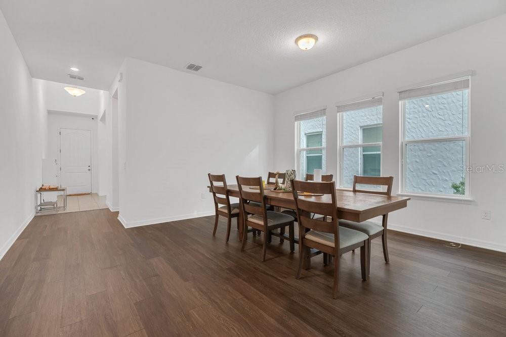 12880 Westside Vlg Loop Windermere, FL 34786 - Photo 13 of 42 a view of a dining room with furniture and wooden floor