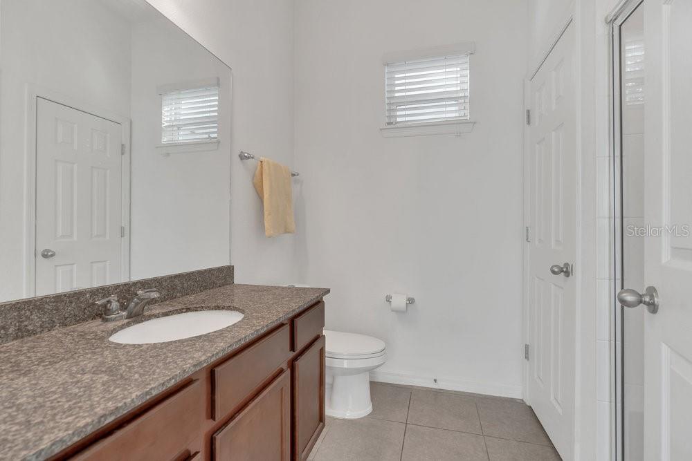 12880 Westside Vlg Loop Windermere, FL 34786 - Photo 29 of 42 a bathroom with a granite countertop sink and a mirror