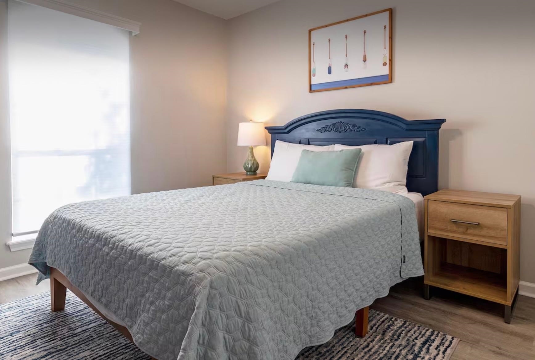 5340 4th Street St. Augustine, FL 32080 - Photo 16 of 29 a bedroom with a bed and a lamp on dresser