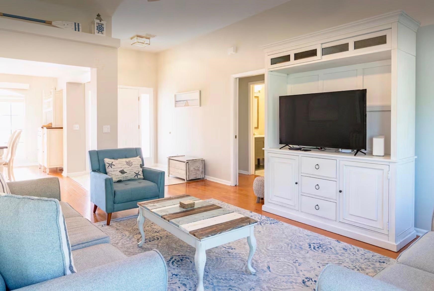 5340 4th Street St. Augustine, FL 32080 - Photo 3 of 29 a living room with furniture a flat screen tv and kitchen view