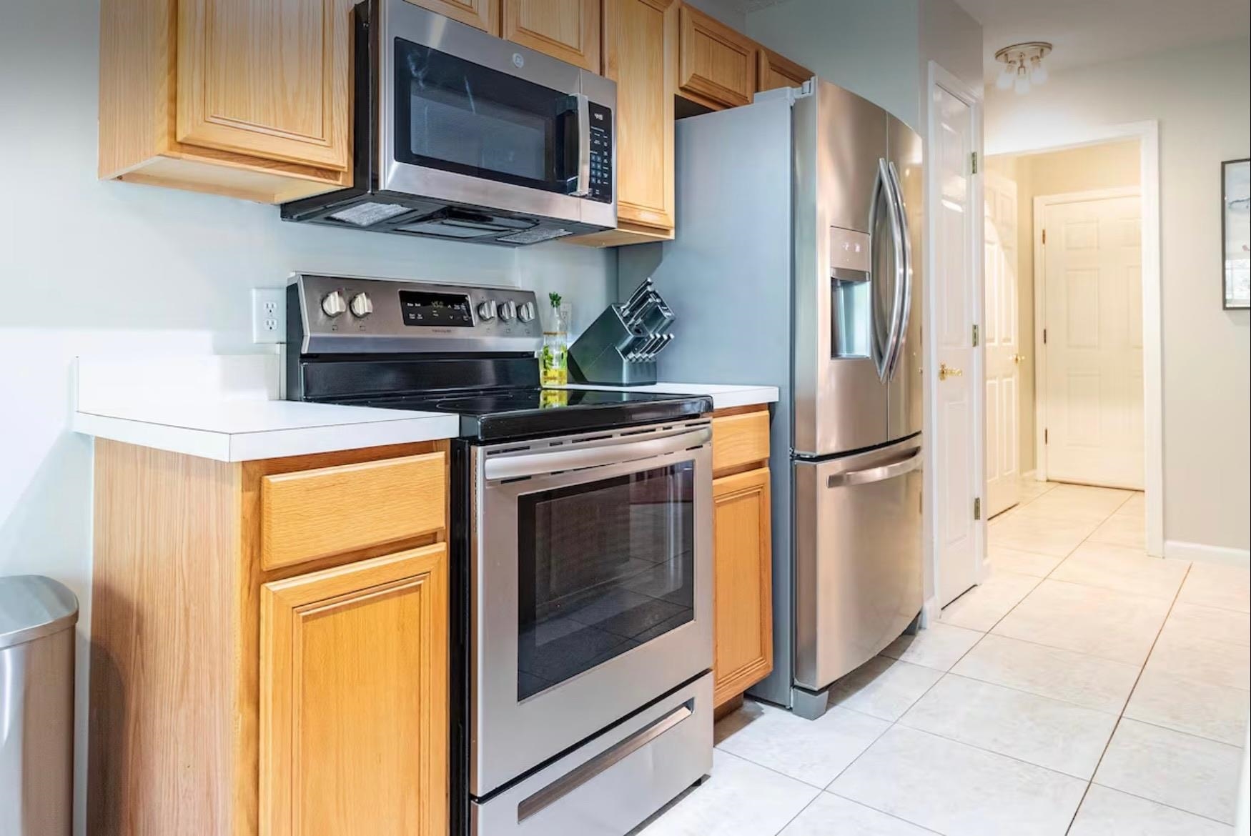 5340 4th Street St. Augustine, FL 32080 - Photo 9 of 29 a kitchen with stainless steel appliances granite countertop a refrigerator stove and microwave