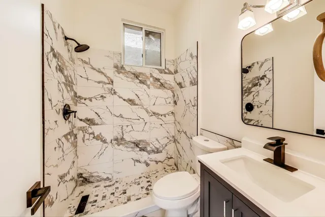 a bathroom with a sink toilet and shower