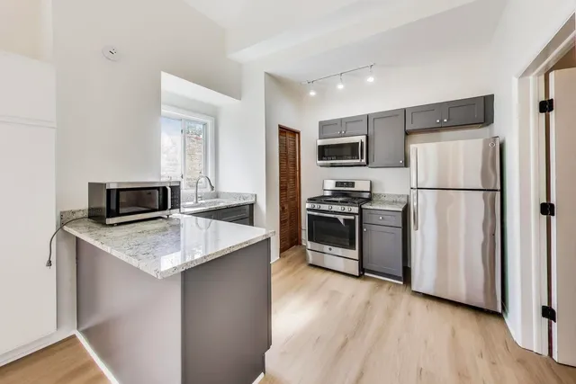 a kitchen with a refrigerator stove and microwave