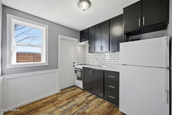 a kitchen with stainless steel appliances granite countertop a refrigerator and a sink