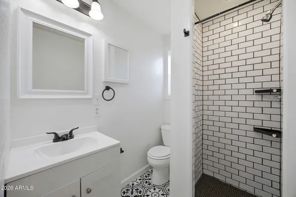 a bathroom with a sink toilet and shower