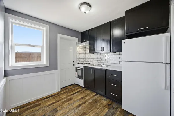 a kitchen with a refrigerator and a sink