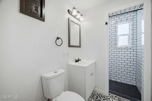 a bathroom with a toilet sink and shower