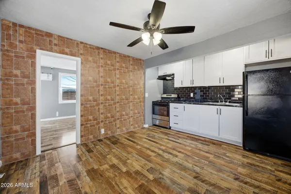 a kitchen with stainless steel appliances a refrigerator sink and cabinets