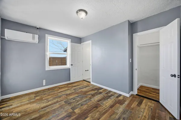 a view of empty room with wooden floor