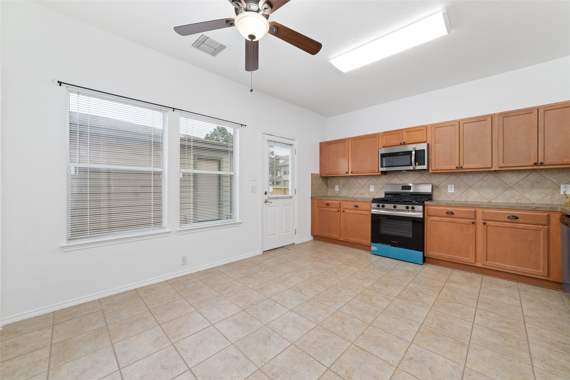 23602 Youpon Lake Lane Spring, TX 77373 - Photo 6 of 21 Bright kitchen and dining area with large windows and backyard access.