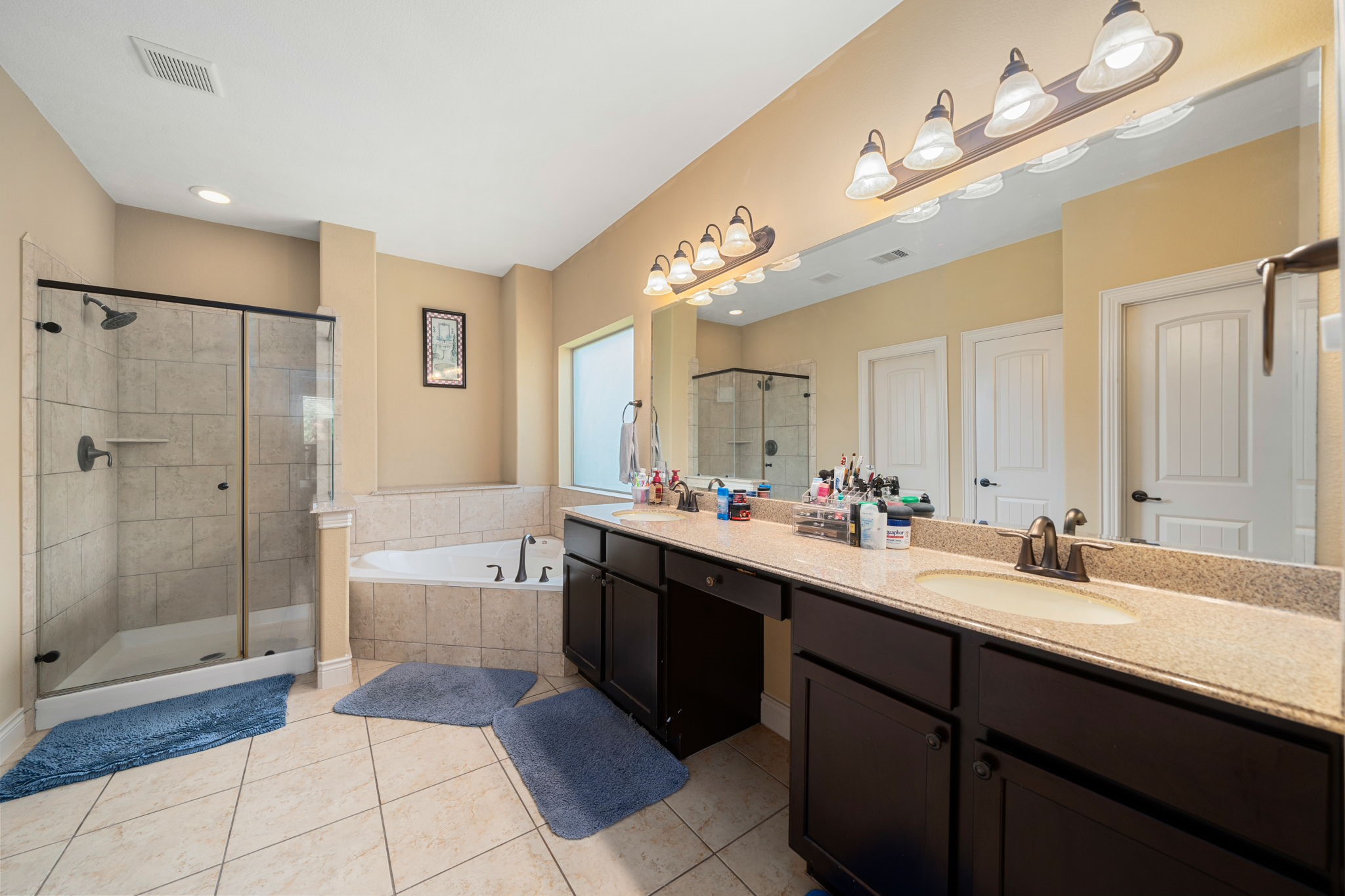 5110 Ruby Rock Way Richmond, TX 77407 - Photo 18 of 27 a spacious bathroom with a bathtub shower sink double and mirror
