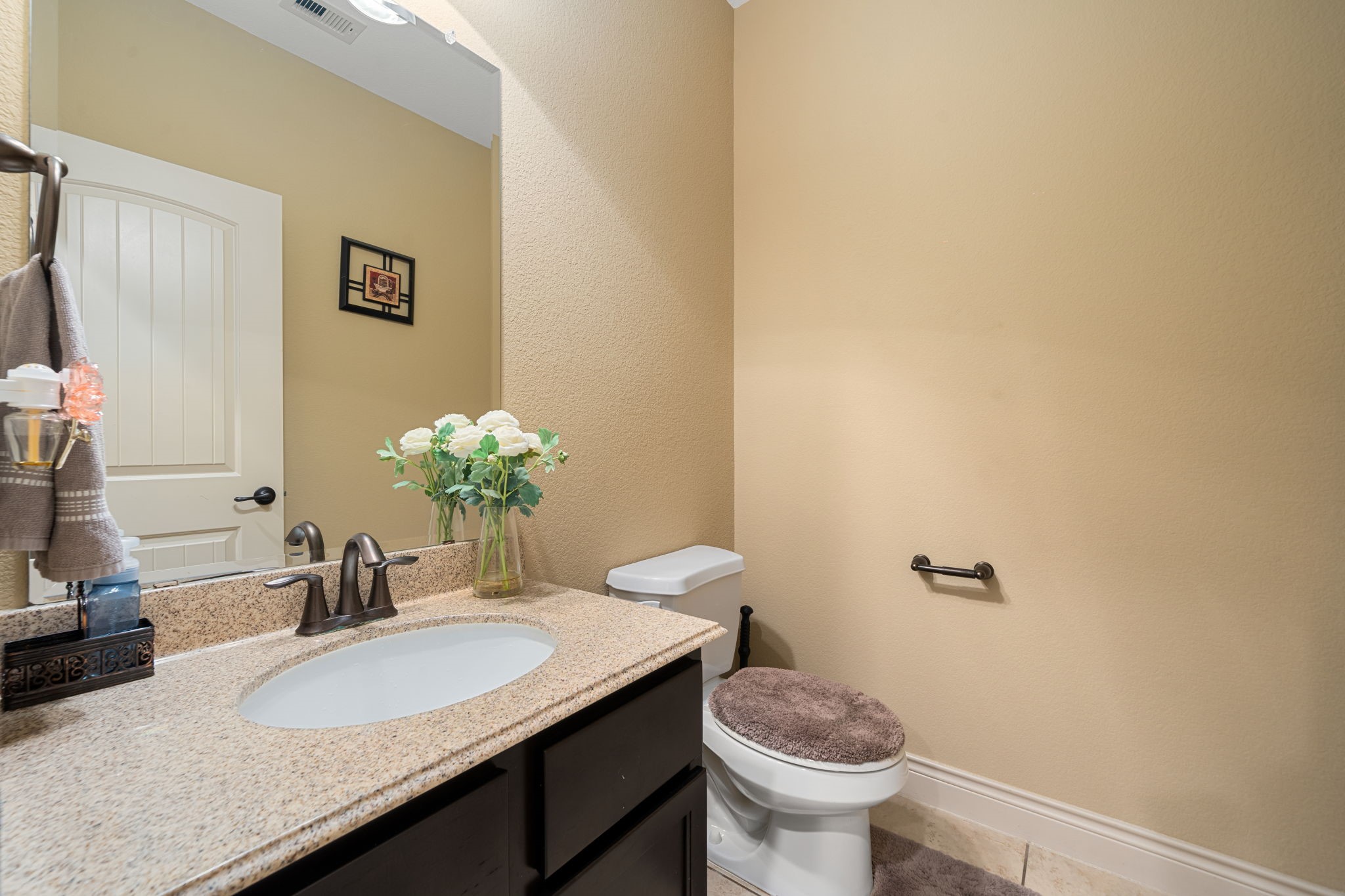5110 Ruby Rock Way Richmond, TX 77407 - Photo 25 of 27 a bathroom with a granite countertop sink a toilet and a mirror
