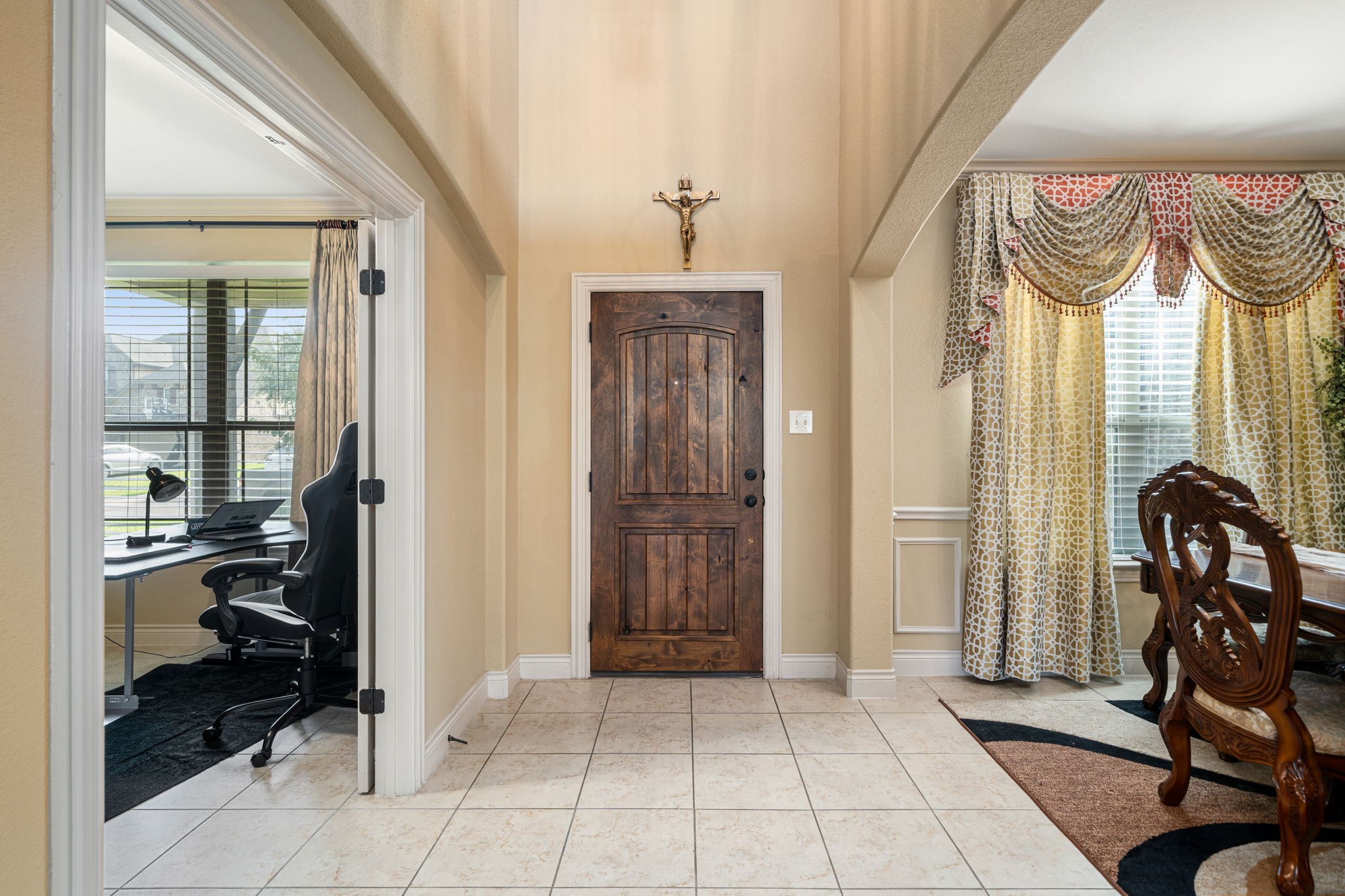 5110 Ruby Rock Way Richmond, TX 77407 - Photo 8 of 27 This photo showcases a welcoming entryway with tile flooring, and an adjacent office space with large windows. To the right, there's a Formal dining area room.