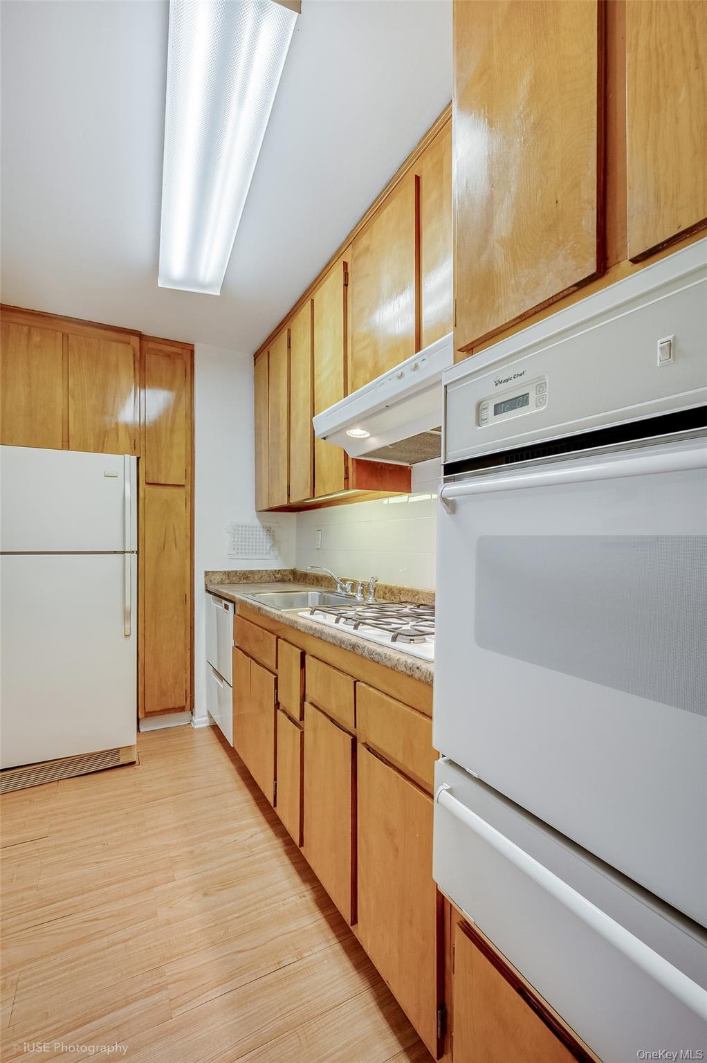 39-65 52nd Street, Unit 2H Queens, NY 11377 - Photo 6 of 18 a kitchen with stainless steel appliances granite countertop a refrigerator and a stove