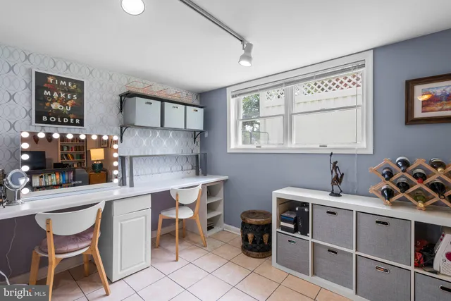 a kitchen with a dining table chairs and white cabinets