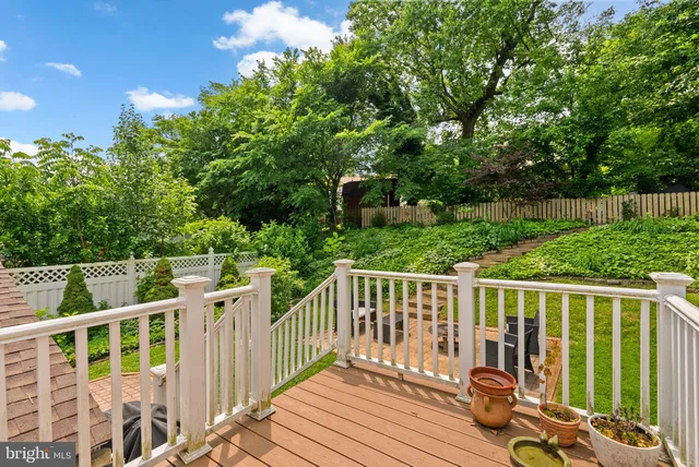 a view of a wooden deck and a backyard with slide
