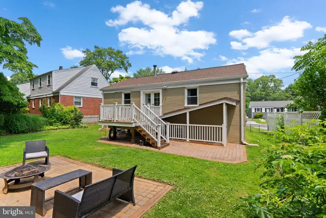 a view of a house with a yard and sitting area