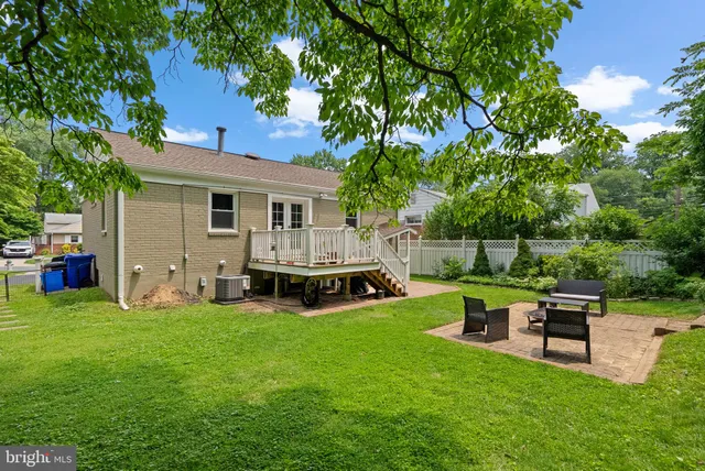 a view of a house with backyard porch and sitting area