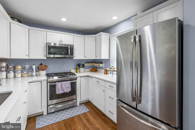 a kitchen with stainless steel appliances a refrigerator sink and microwave