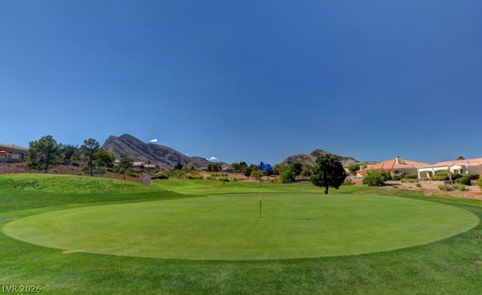 2716 Showcase Drive Las Vegas, NV 89134 - Photo 38 of 45 Green fairways stretch towards distant mountains, offering serene views from this golf course community.